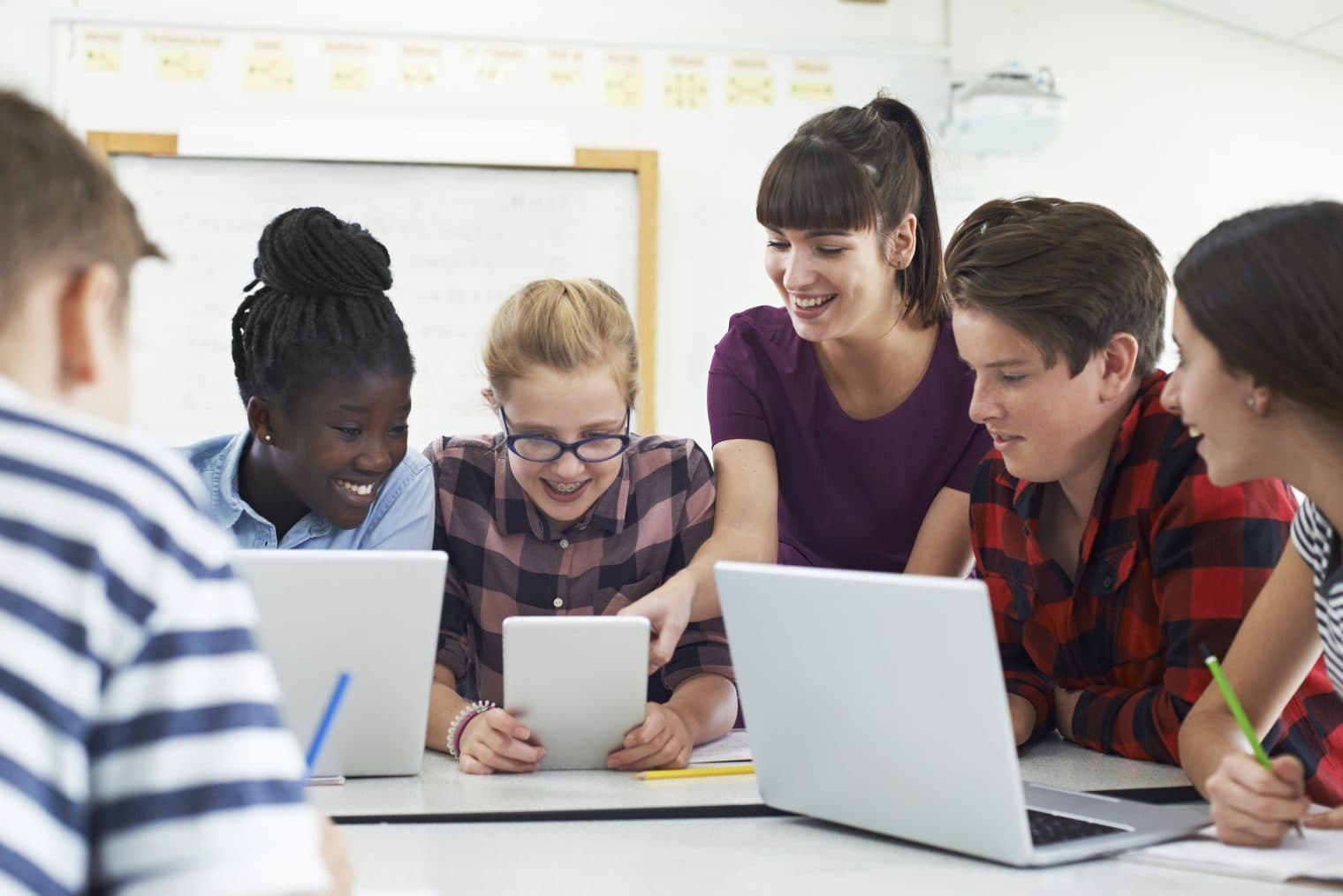Diverse group of teenage Students With teacher in an IT class.