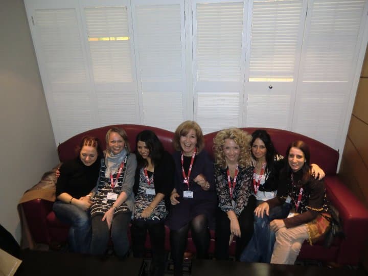 Marisa with a group of women sat happily on a sofa at a 'tweet-up' at Iatefl.