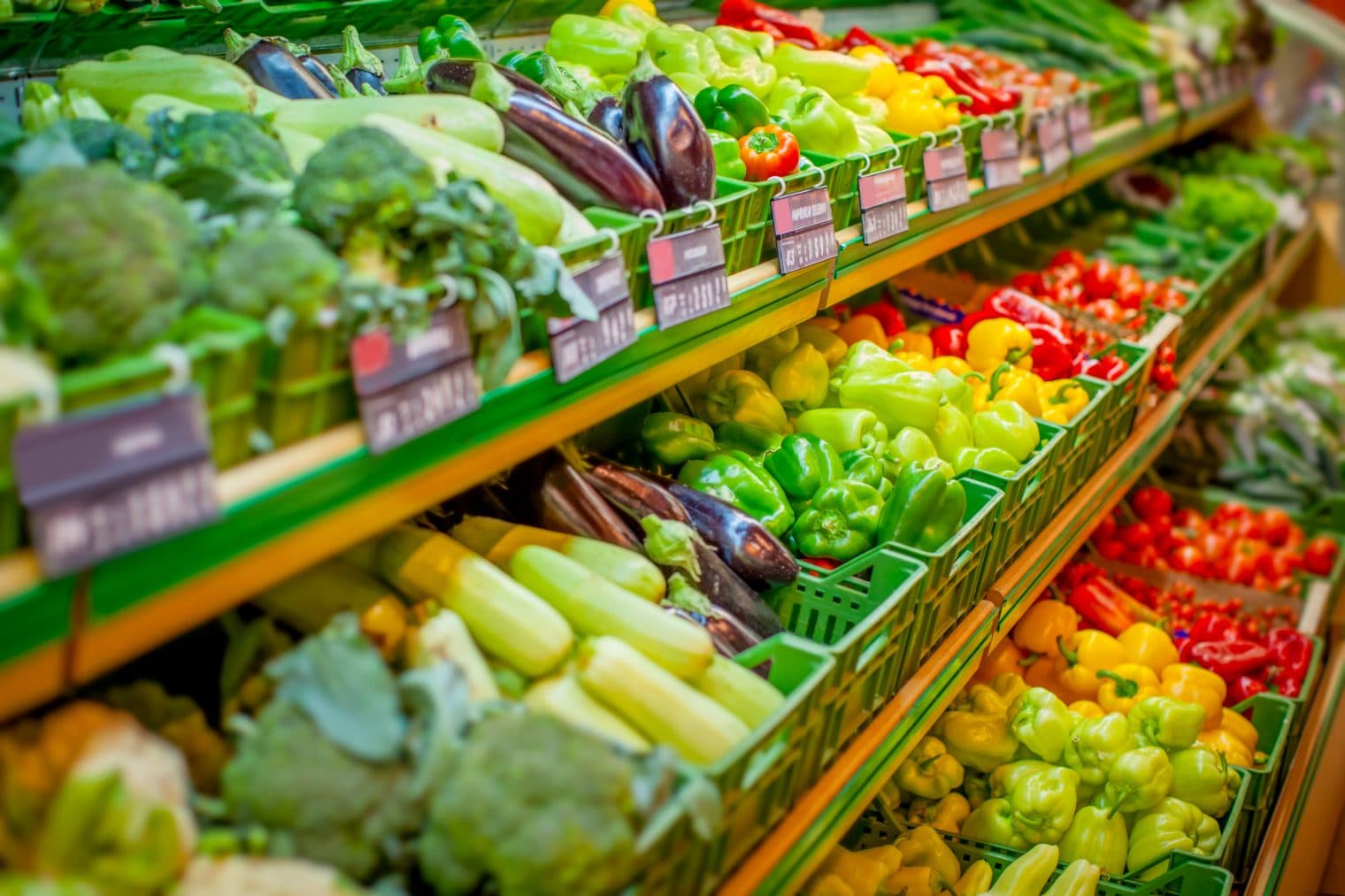 Lots of different coloured vegetables at the supermarket.