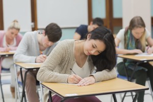 Students in a classroom sitting at their desks while doing a test