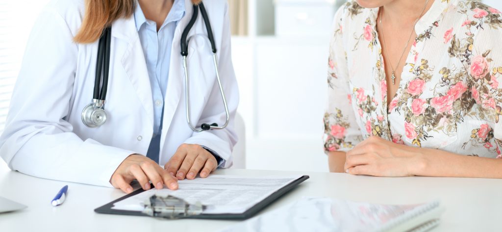 A female doctor showing a chart to a female patient