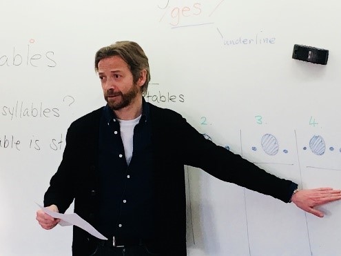 Photo of Mark McKinnon standing in front of a whiteboard.